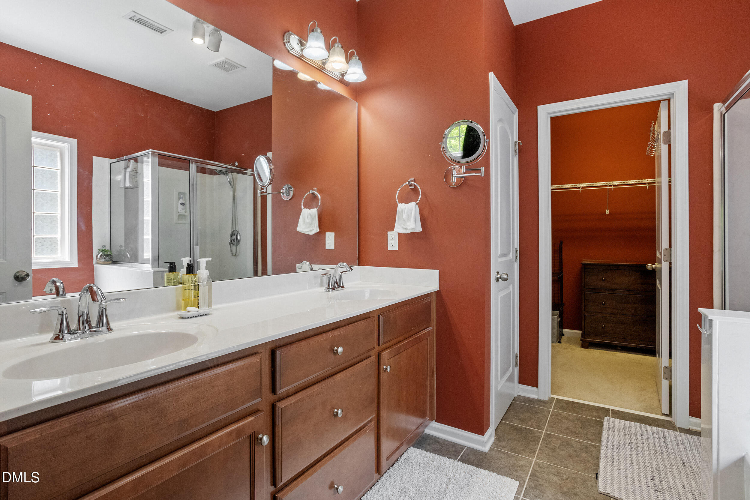 235 Strolling Way Durham, NC 27707 - Photo 22 of 32 a bathroom with a double vanity sink and a mirror
