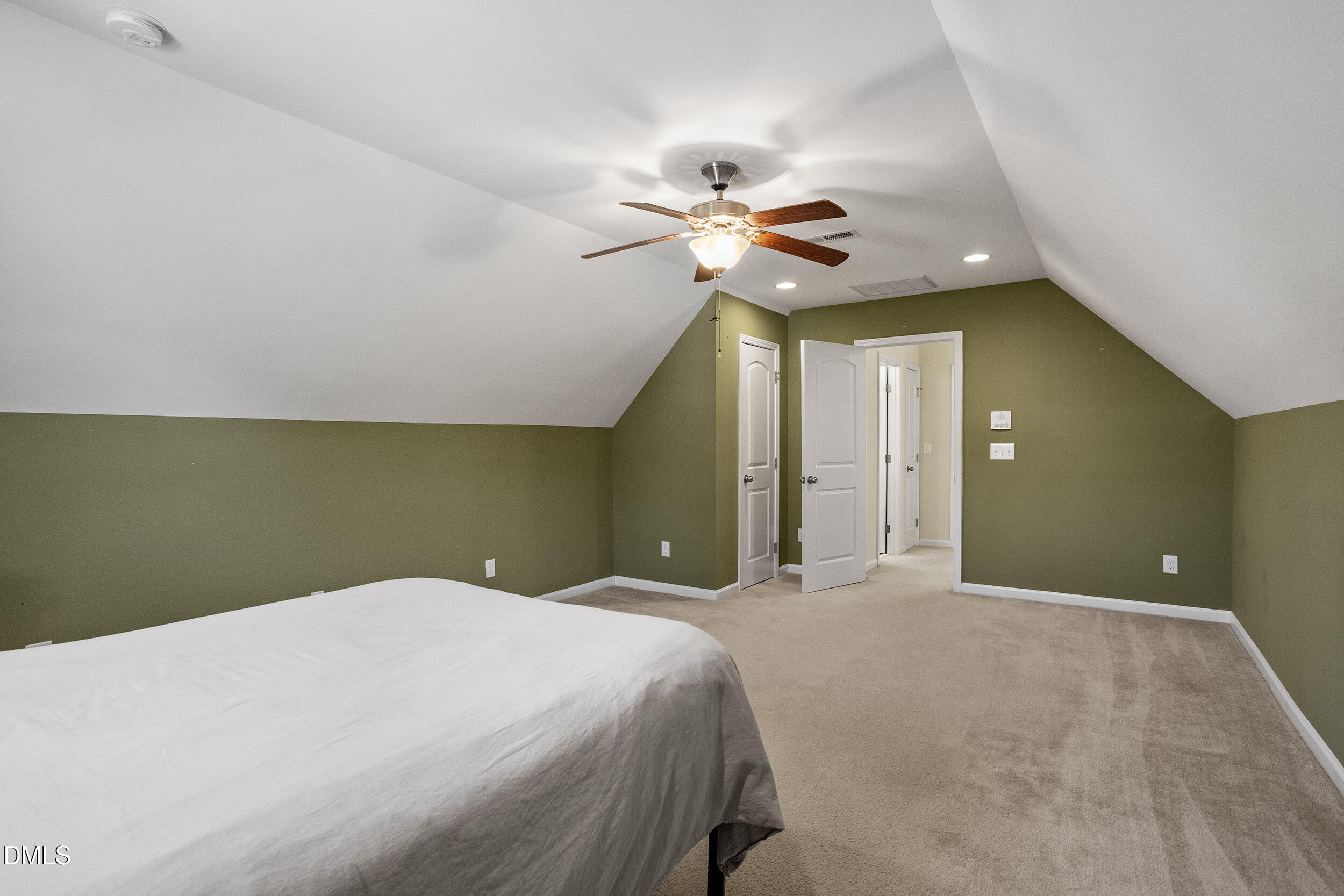 235 Strolling Way Durham, NC 27707 - Photo 28 of 32 a bedroom with a bed and a chandelier