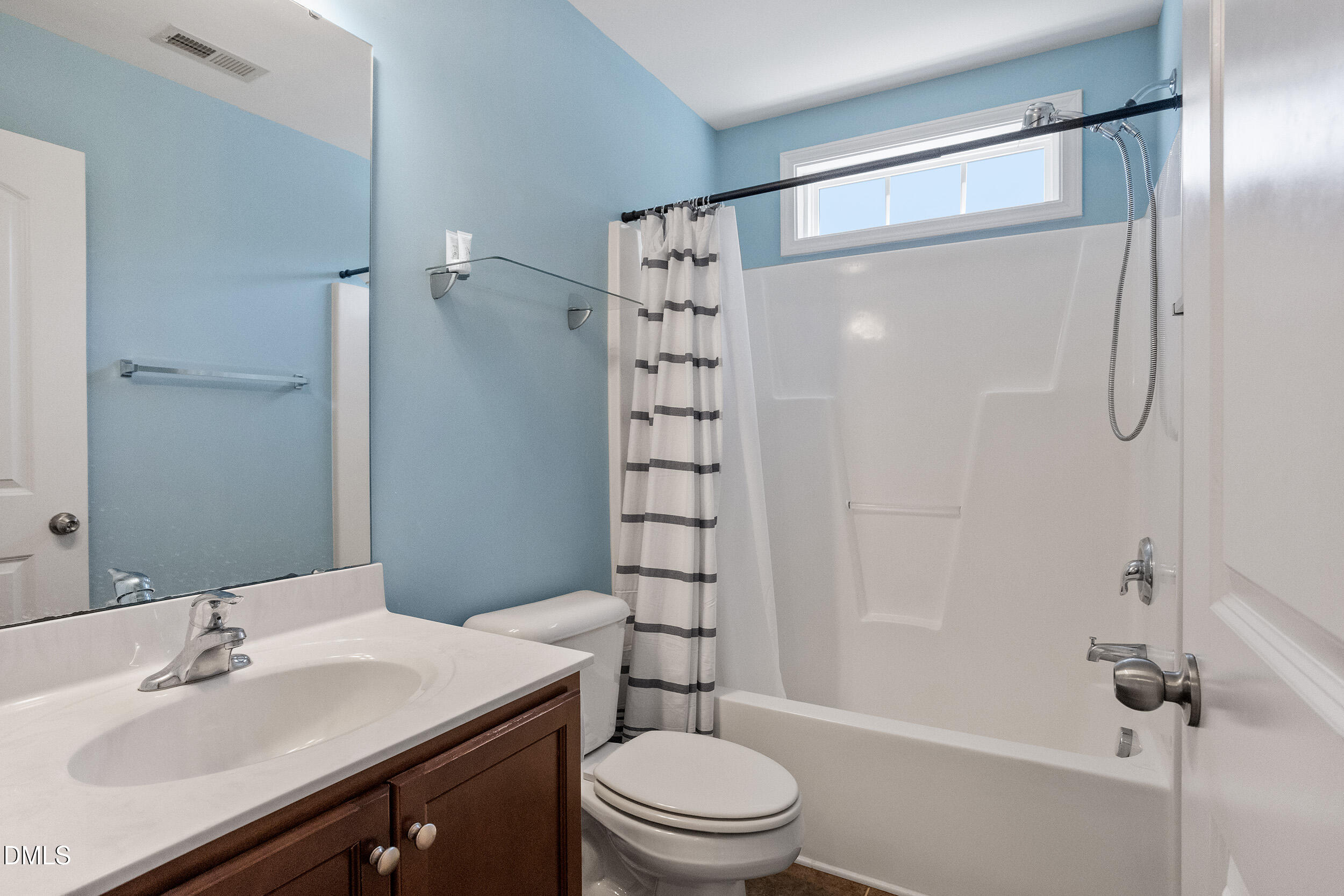 235 Strolling Way Durham, NC 27707 - Photo 29 of 32 a bathroom with a sink a toilet and shower