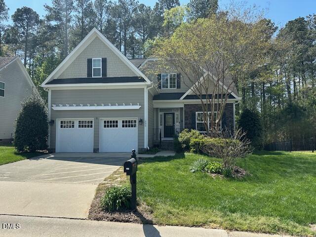 235 Strolling Way Durham, NC 27707 - Photo 4 of 32 front view of house with a yard