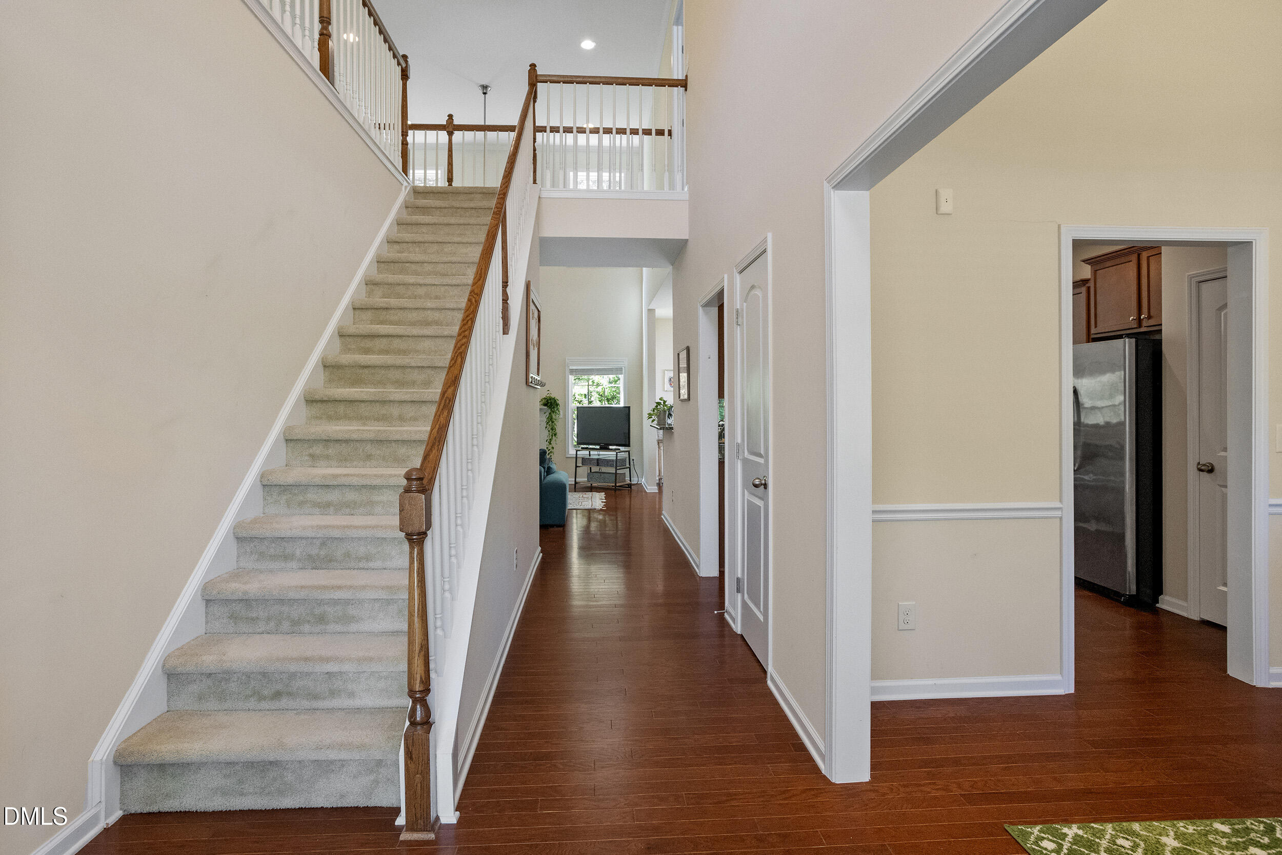 235 Strolling Way Durham, NC 27707 - Photo 8 of 32 a view of a hallway with wooden floor and entryway