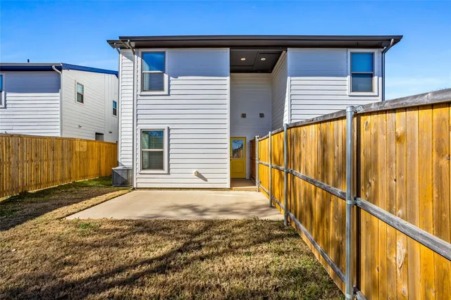 an aerial view of a house with swimming pool and trees