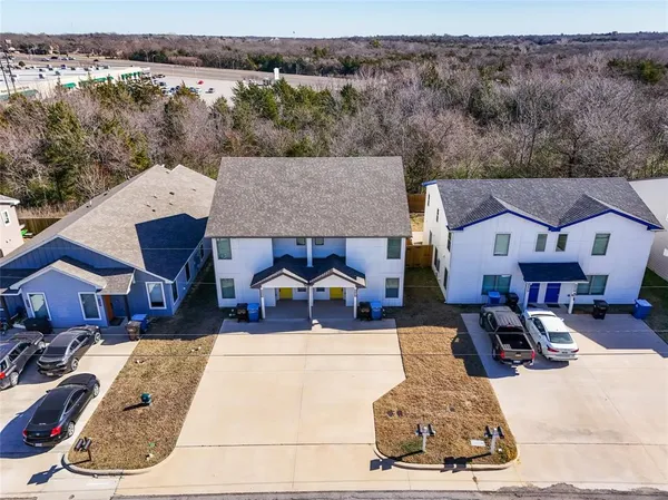 an aerial view of residential houses with outdoor space
