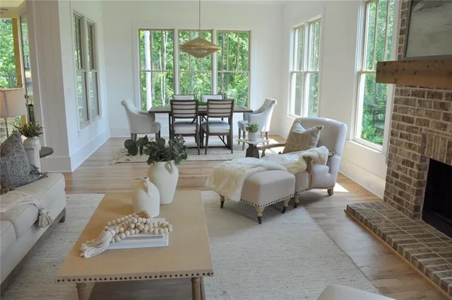 a living room with furniture large windows and a fireplace