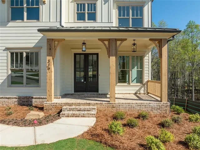 a view of a white house with large windows