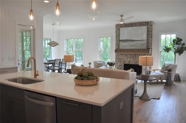 a living room with furniture kitchen view and a fireplace