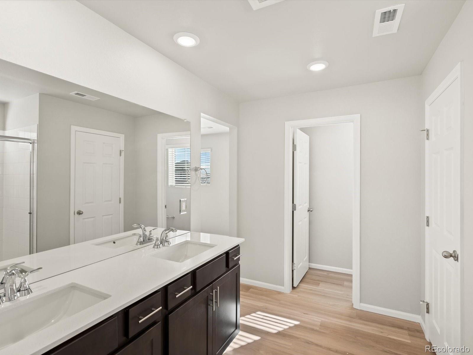 4673 Rabbitbrush Street Johnstown, CO 80534 - Photo 21 of 31 a bathroom with a double vanity sink and a mirror