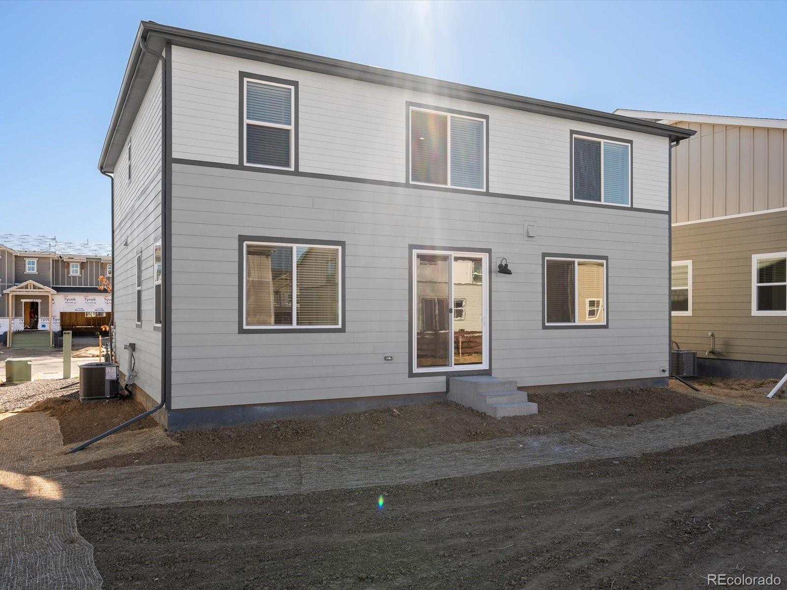 4673 Rabbitbrush Street Johnstown, CO 80534 - Photo 28 of 31 a front view of a house with a yard