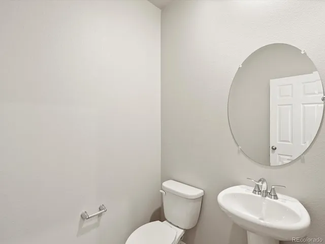 a bathroom with a sink a mirror and a toilet