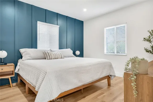 a bedroom with a bed and a flat screen tv