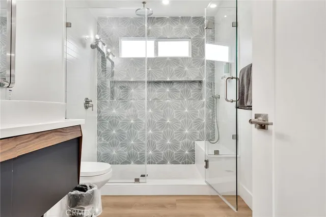 a bathroom with a sink a toilet and shower