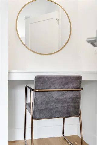 a wooden bench sitting in backside of a house with potted plants and wooden fence