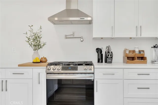 a kitchen with a stove and cabinets