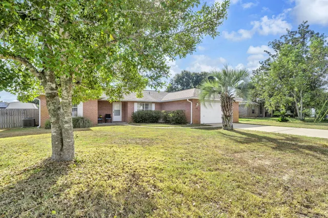 a front view of house with yard and green space