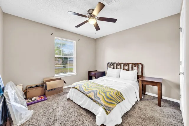 a bedroom with a bed and a couch