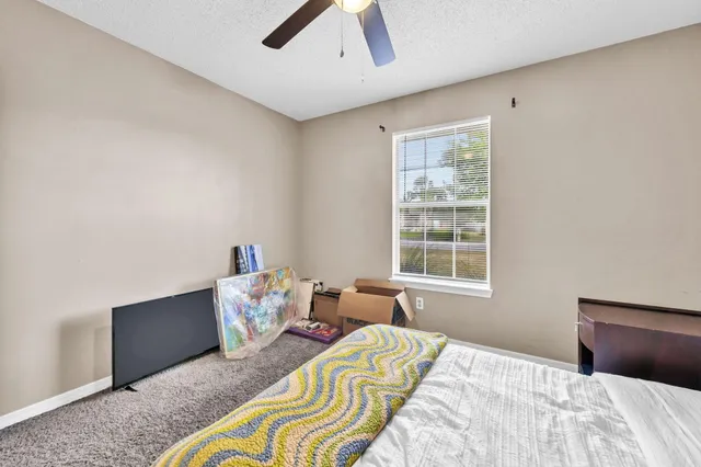 a bedroom with bed and window