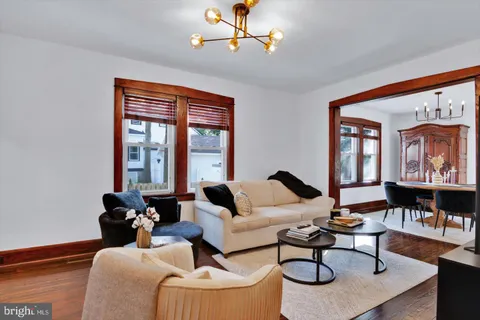 a living room with furniture a fireplace and a window