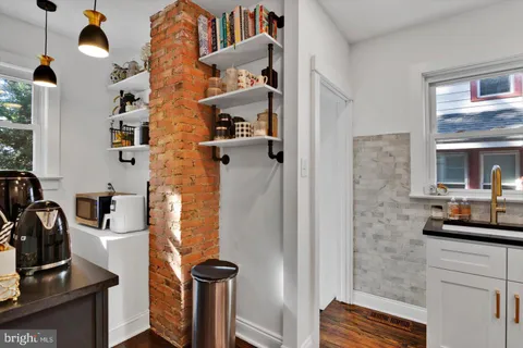 a bathroom with a toilet a sink and a mirror