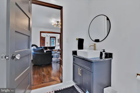 a bedroom with a bed and painting on the wall