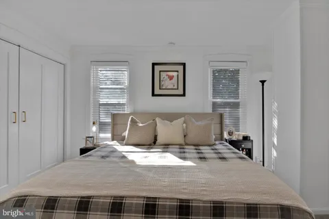 a bedroom with a bed and a painting on the wall