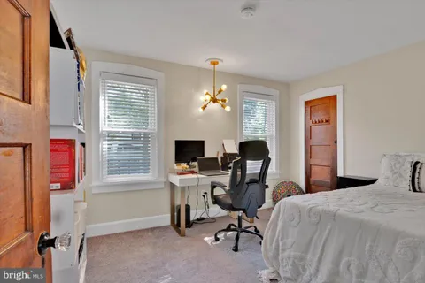 a bedroom with a workspace