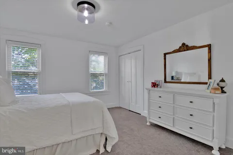 a bedroom with a bed and a large mirror