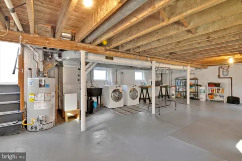a view of a patio with table and chairs with wooden fence and plants