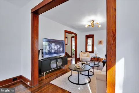 a living room with furniture chandelier and a window