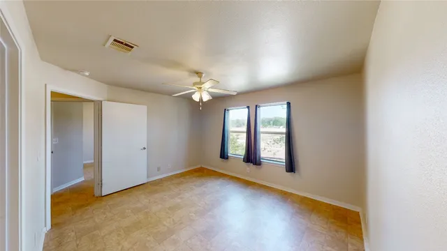 a view of a livingroom with a ceiling fan and window