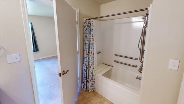 a bathroom with a bathtub and a shower