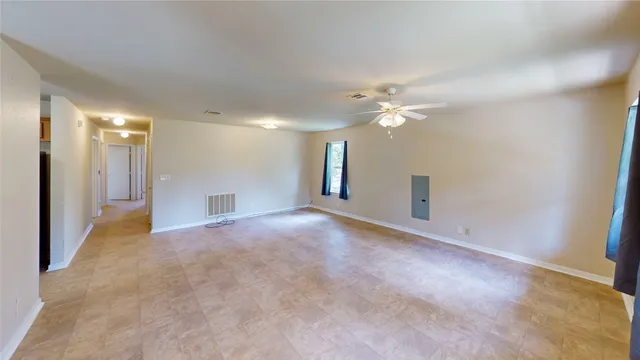 a view of a livingroom with a ceiling fan and window