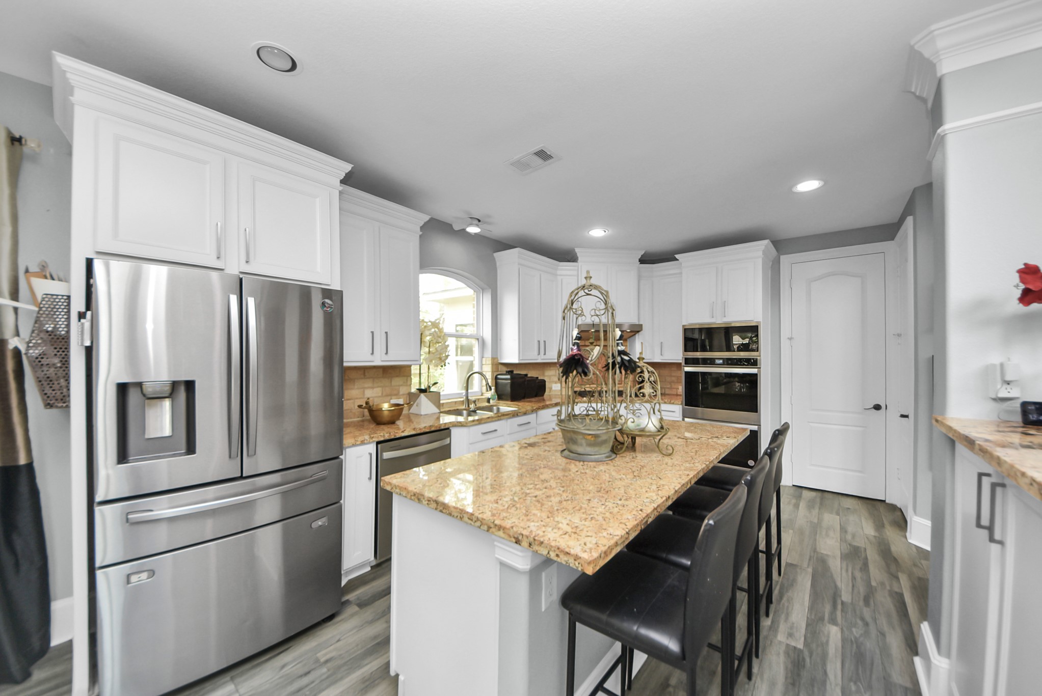 28115 Kudzu Drive Spring, TX 77386 - Photo 11 of 39 a kitchen with kitchen island a refrigerator stove microwave and cabinets
