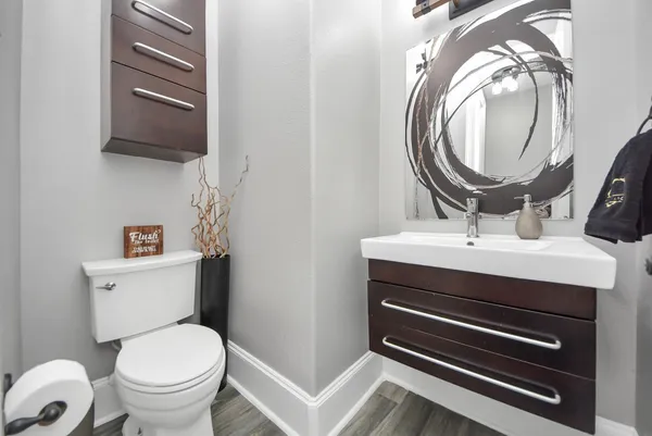 a bathroom with a sink a mirror and a toilet