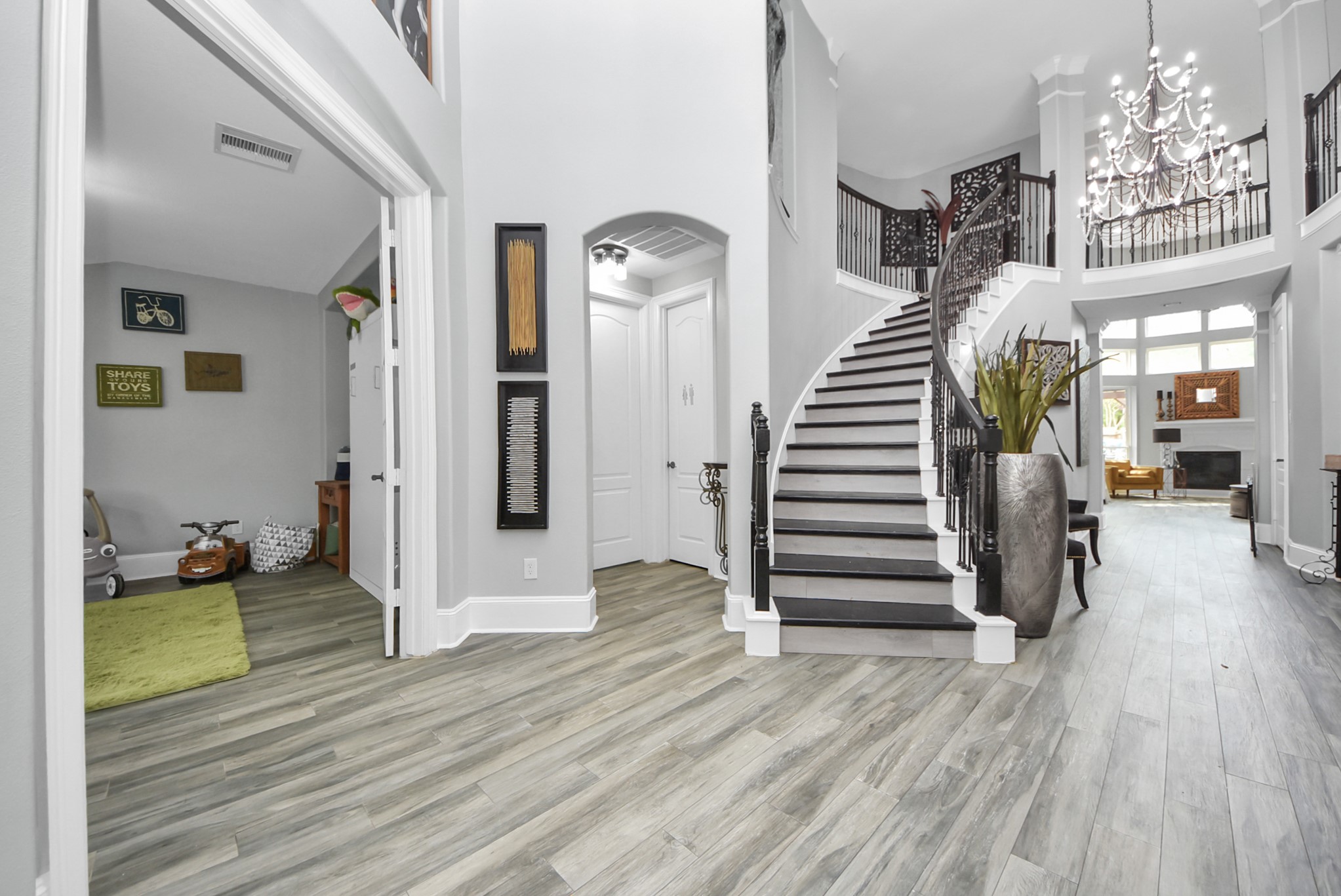 28115 Kudzu Drive Spring, TX 77386 - Photo 5 of 39 a view of a hallway with wooden floor staircase and a living room