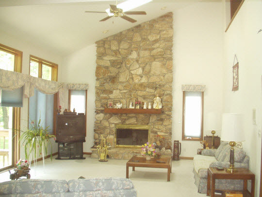 1151 Krupke Road Caledonia, IL 61011 - Photo 4 of 7 a living room with furniture and a fireplace