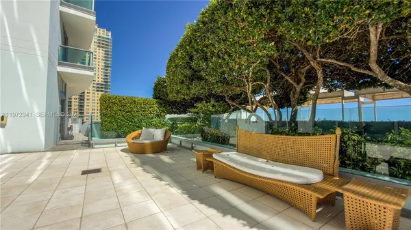 a view of a patio with couches and a potted plant on a table
