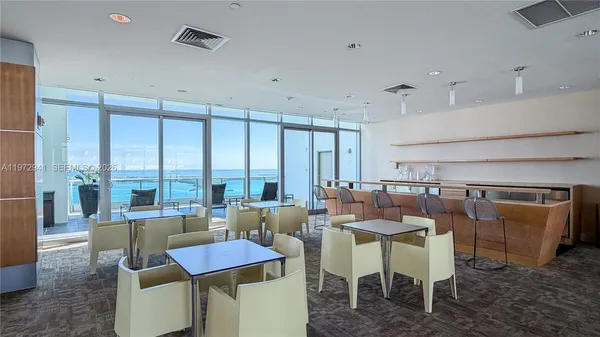 a dining room with furniture a chandelier and a rug