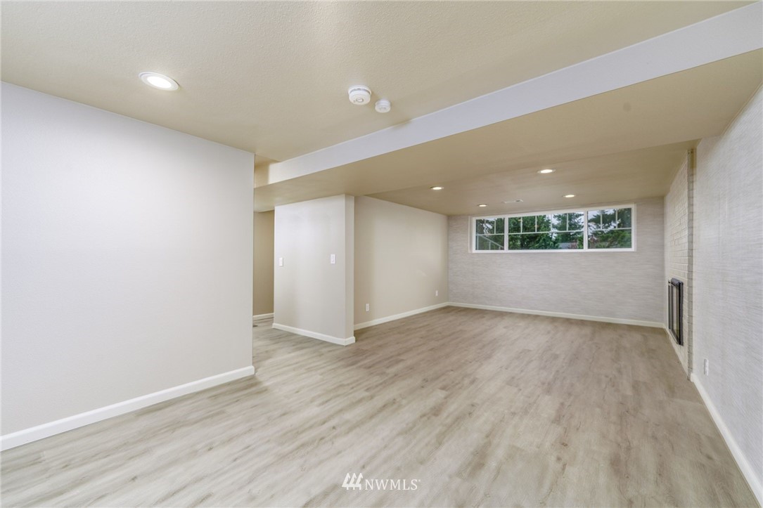 2926 Northeast 5th Place Renton, WA 98056 - Photo 13 of 40 an empty room with wooden floor and windows