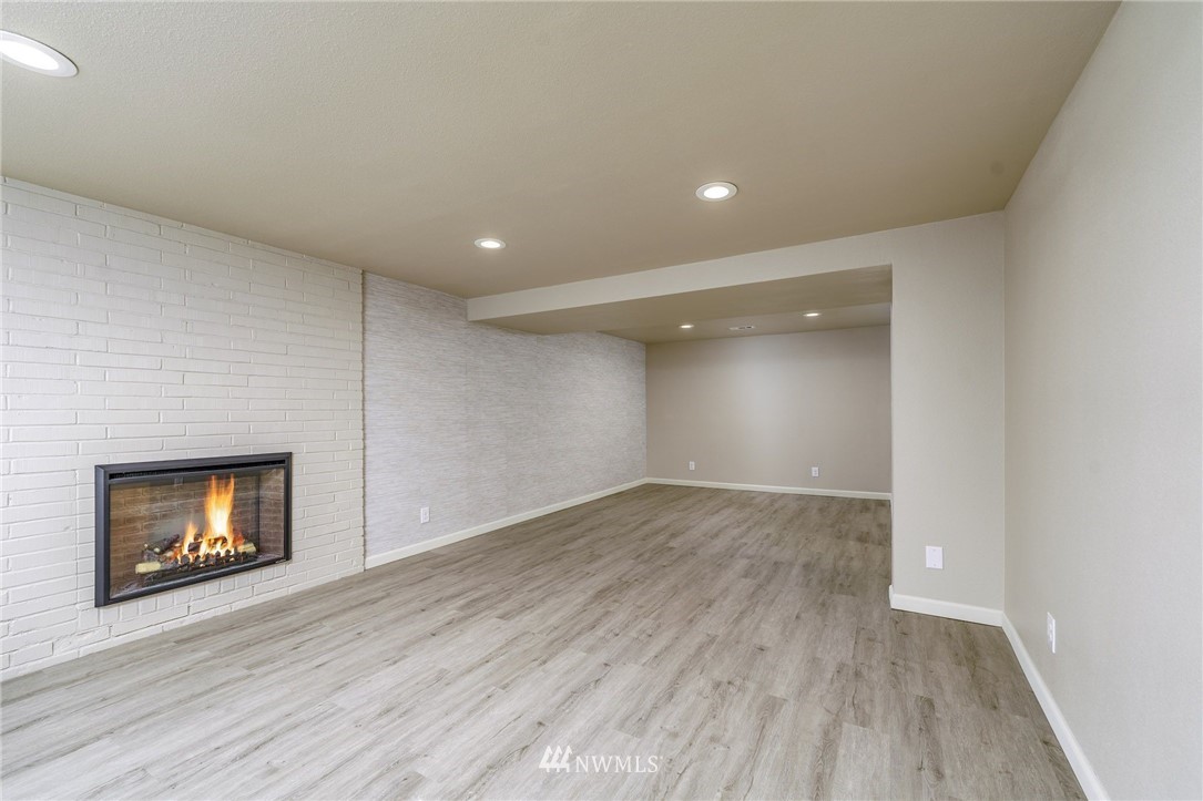 2926 Northeast 5th Place Renton, WA 98056 - Photo 14 of 40 a view of an empty room with a fireplace and a window