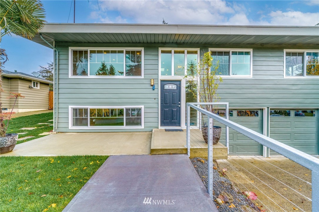 2926 Northeast 5th Place Renton, WA 98056 - Photo 2 of 40 a front view of a house with a yard and garage