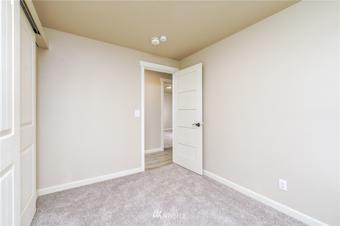 2926 Northeast 5th Place Renton, WA 98056 - Photo 22 of 40 a view of an empty room with wooden floor and a window