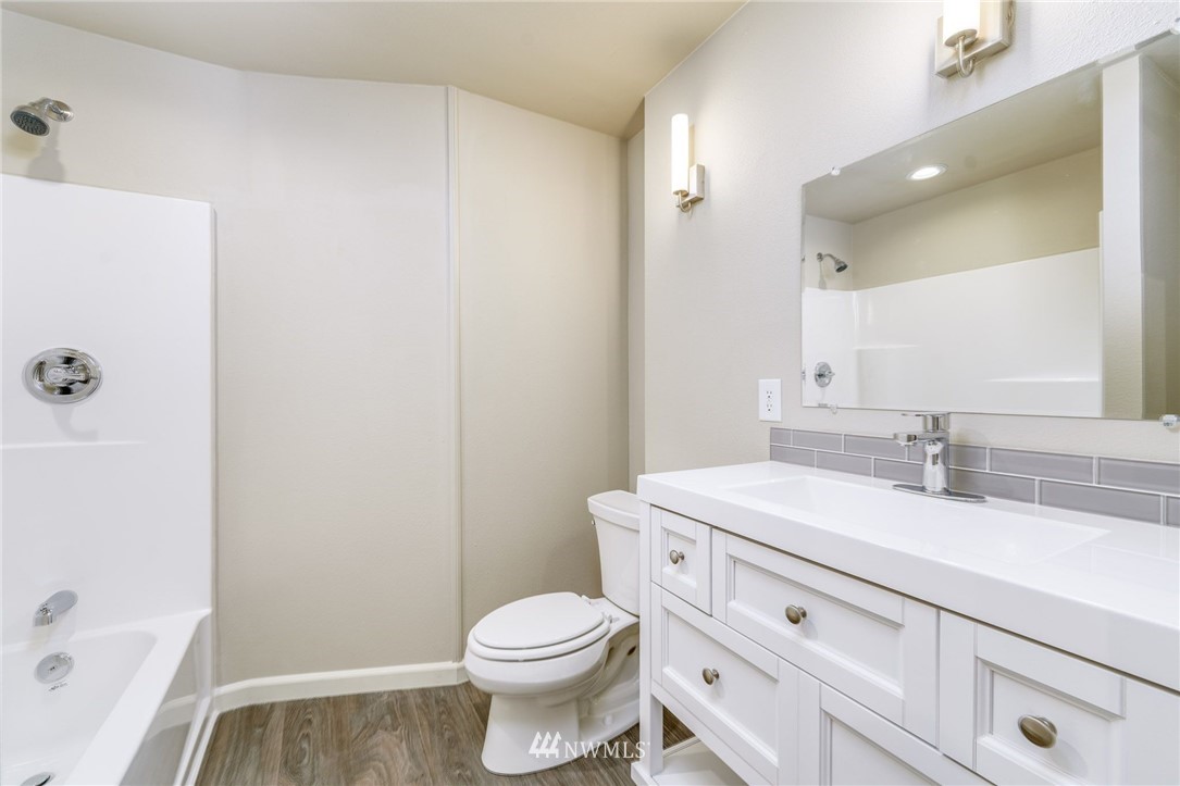 2926 Northeast 5th Place Renton, WA 98056 - Photo 25 of 40 a bathroom with a sink a toilet and shower