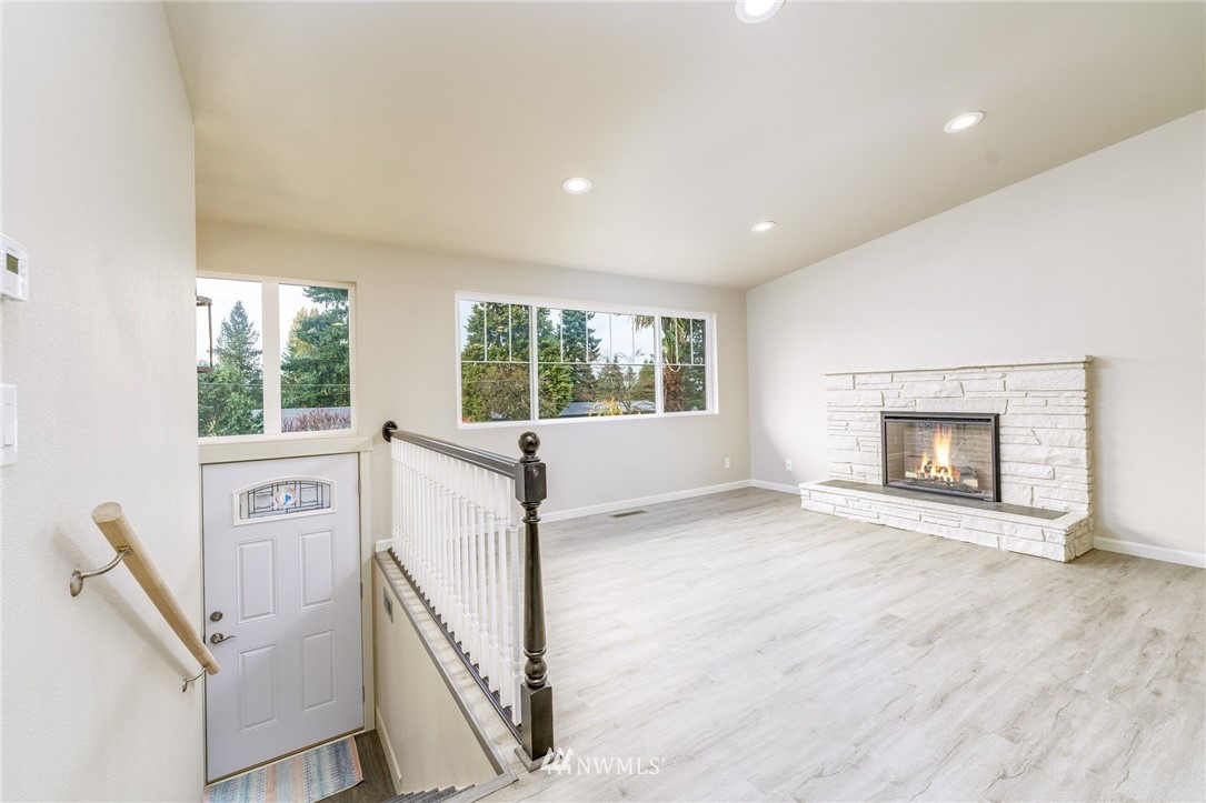 2926 Northeast 5th Place Renton, WA 98056 - Photo 9 of 40 a view of an empty room with a fireplace and a window
