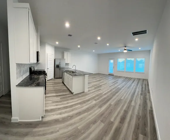 a kitchen with a sink and a refrigerator