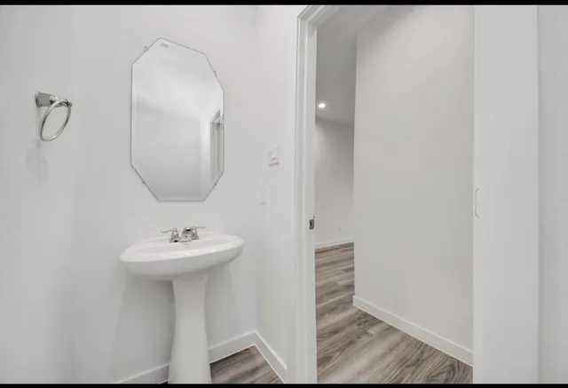 a bathroom with a sink a mirror and shower