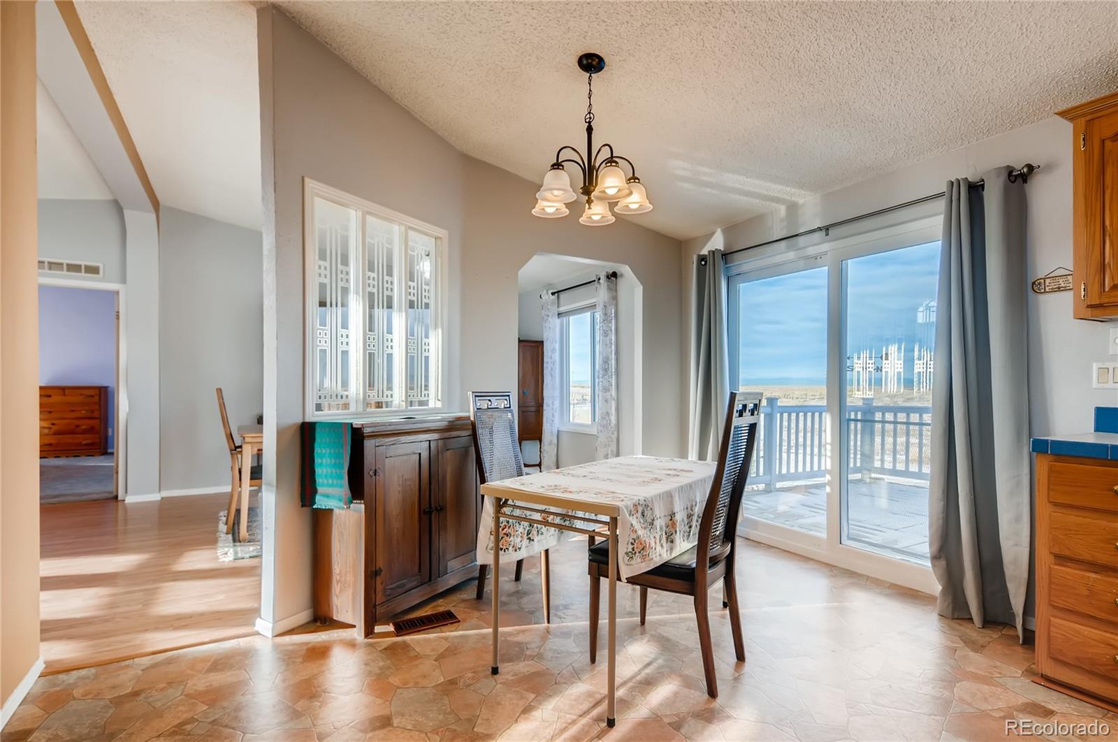 13801 Cavanaugh Road Hudson, CO 80642 - Photo 12 of 39 a view of a dining room with furniture and wooden floor