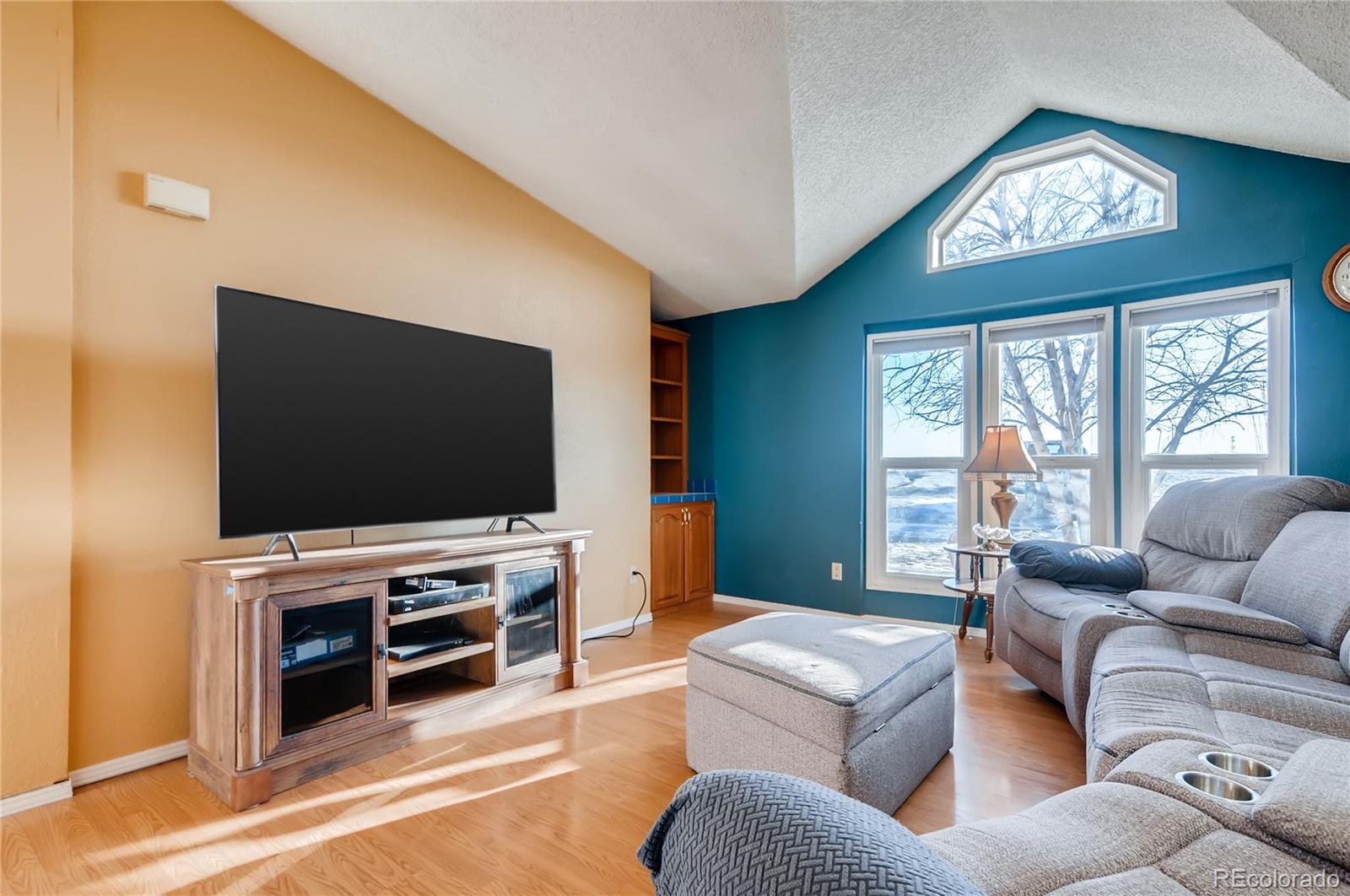 13801 Cavanaugh Road Hudson, CO 80642 - Photo 13 of 39 a living room with furniture and a flat screen tv