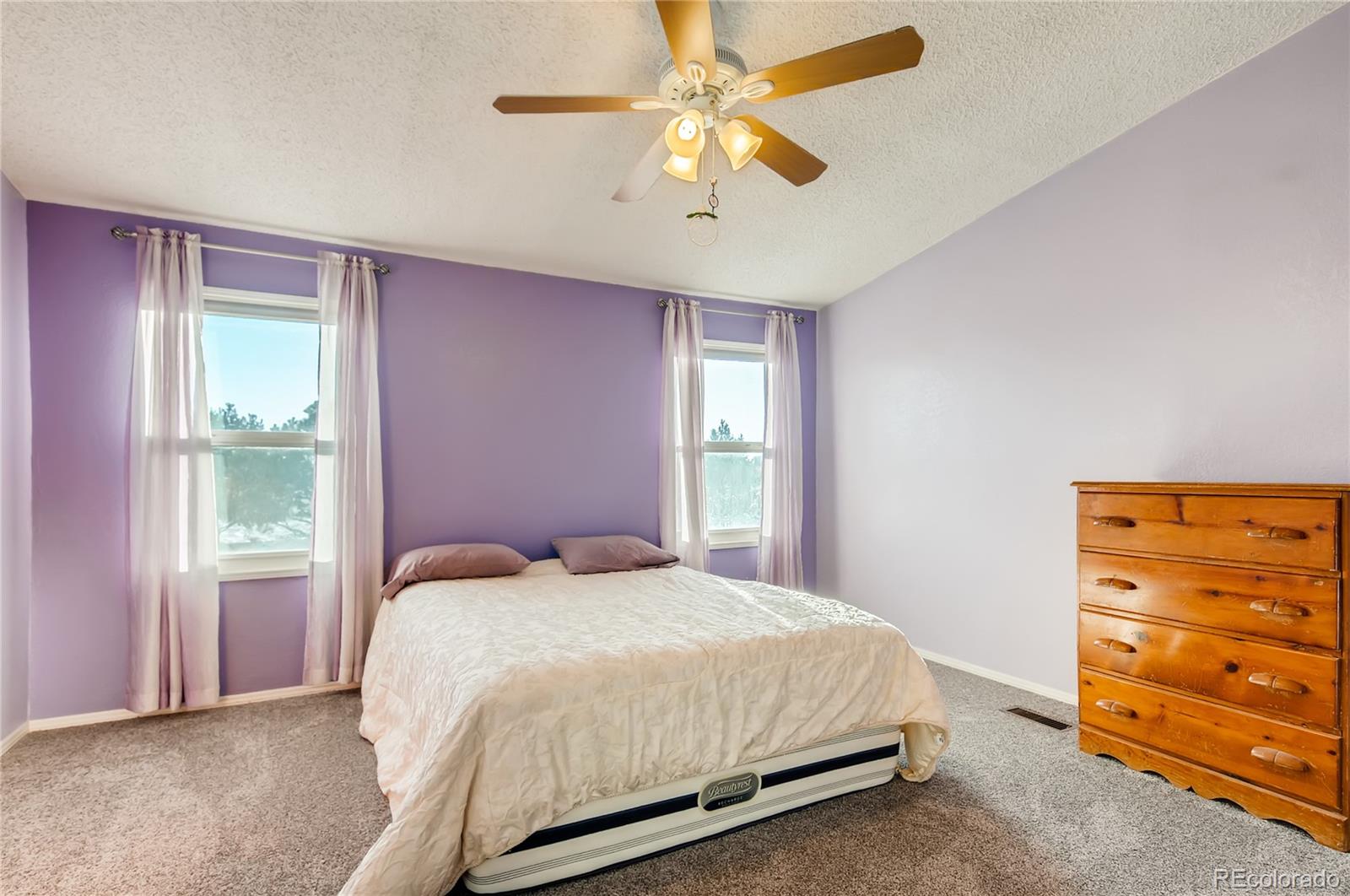 13801 Cavanaugh Road Hudson, CO 80642 - Photo 14 of 39 a bedroom with a bed and a dresser