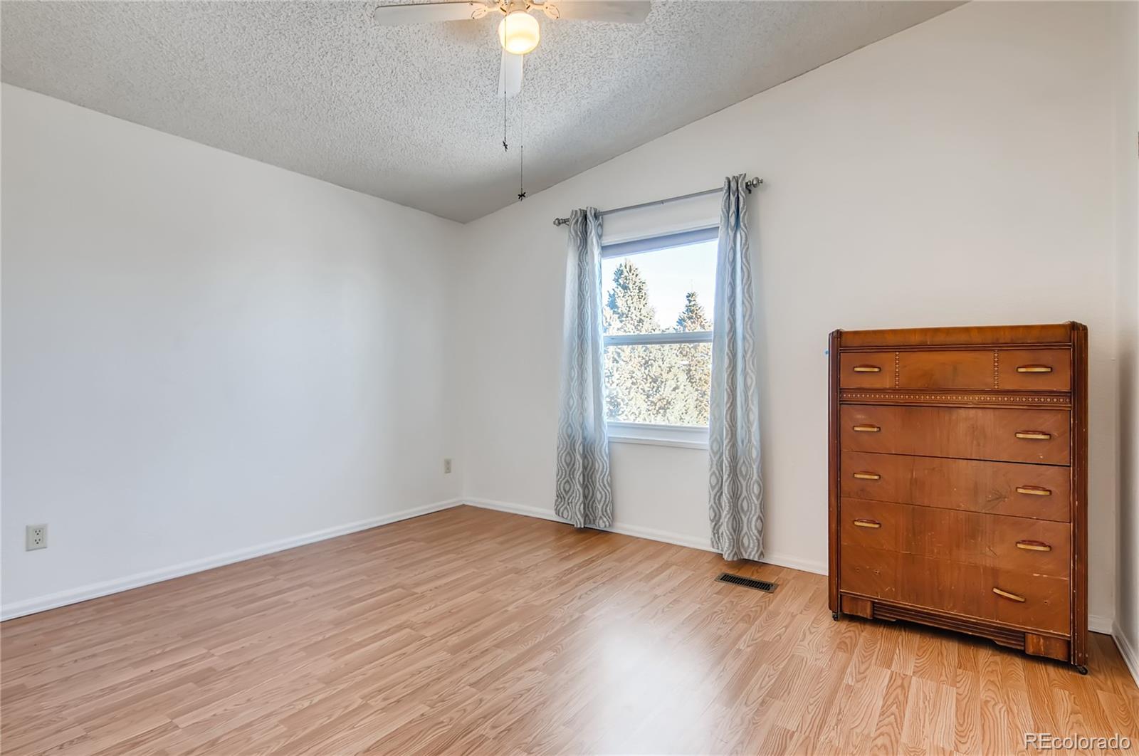 13801 Cavanaugh Road Hudson, CO 80642 - Photo 17 of 39 an empty room with wooden floor closet and windows