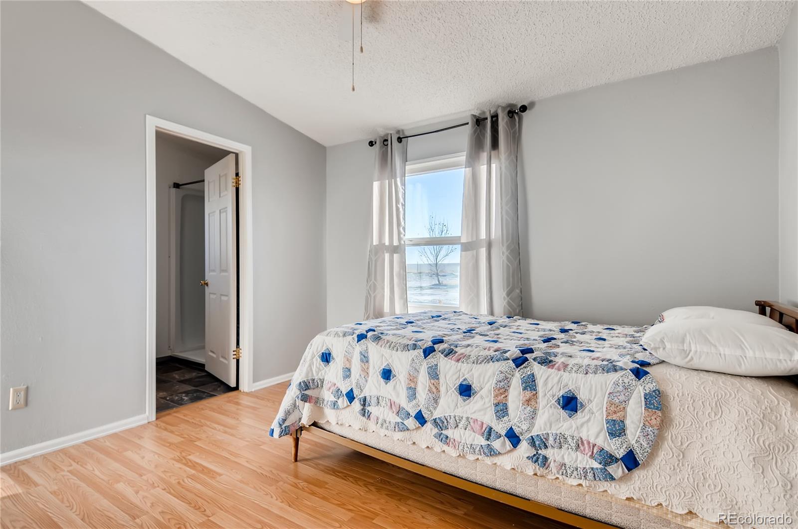 13801 Cavanaugh Road Hudson, CO 80642 - Photo 18 of 39 a bedroom with a bed and a window